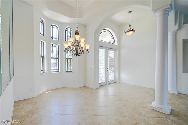 foyer entrance featuring french doors, a chandelier, a wealth of natural light, and light tile patterned floors