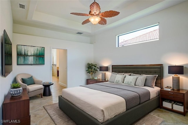 tiled bedroom featuring ceiling fan and a raised ceiling