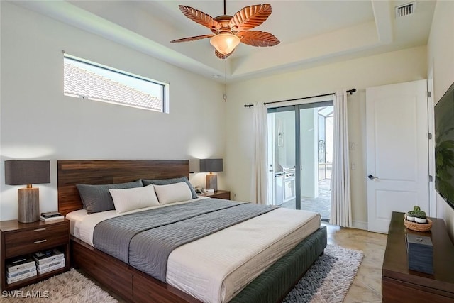 bedroom featuring ceiling fan, access to outside, and a raised ceiling