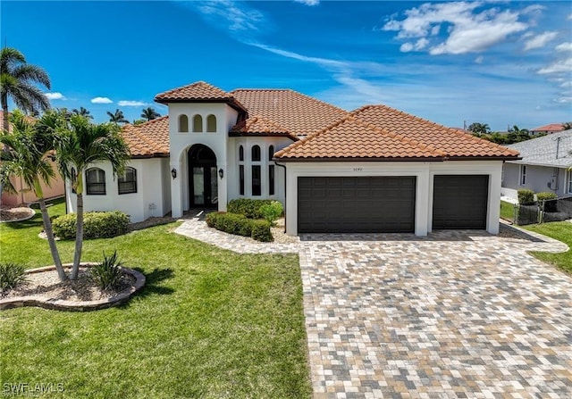 mediterranean / spanish home with a front yard and a garage