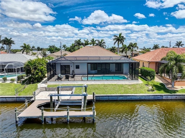 back of property featuring a lanai, a patio, a lawn, and a water view