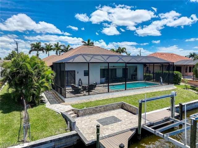 rear view of house with a yard, a lanai, a water view, and a patio