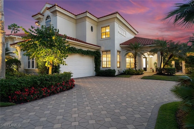 mediterranean / spanish house featuring a garage