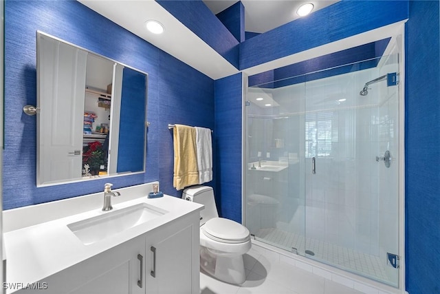 bathroom featuring tile patterned floors, vanity, toilet, and an enclosed shower