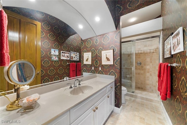 bathroom featuring a shower with shower door, toilet, lofted ceiling, and vanity