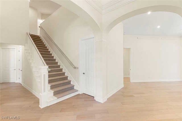 8723 La Palma Ln, Naples, FL 34108 - stairs with wood finished floors, arched walkways, and crown molding