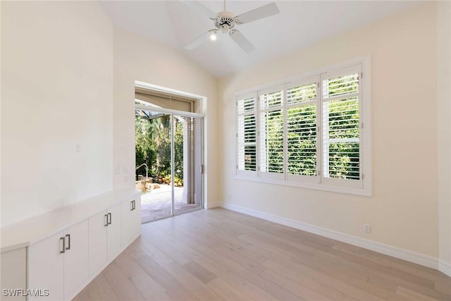 8723 La Palma Ln, Naples, FL 34108 - empty room featuring healthy amount of natural light, light wood finished floors, vaulted ceiling, and a ceiling fan