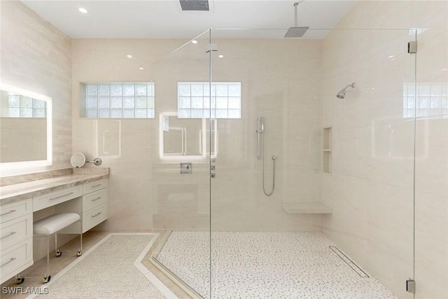 8723 La Palma Ln, Naples, FL 34108 - bathroom featuring a stall shower, vanity, and tile walls