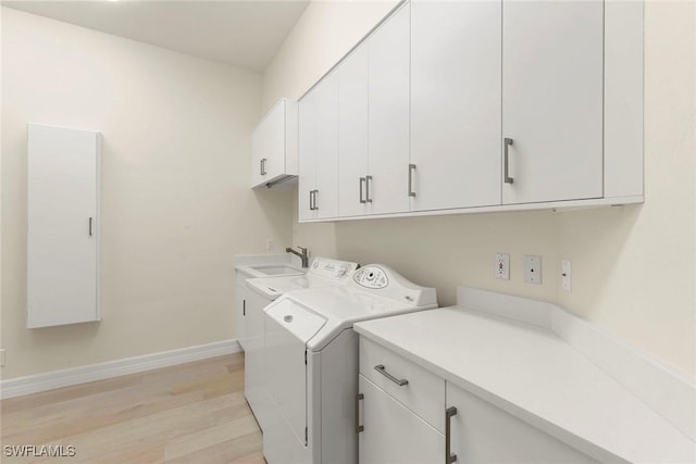 8723 La Palma Ln, Naples, FL 34108 - laundry area featuring cabinet space, separate washer and dryer, and light wood-style flooring