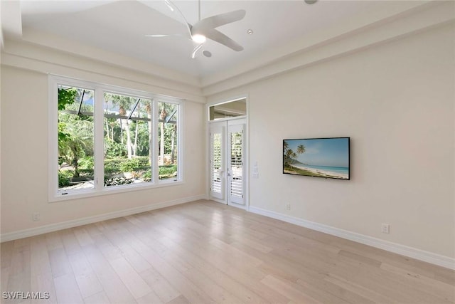 8723 La Palma Ln, Naples, FL 34108 - spare room with healthy amount of natural light, ceiling fan, light wood finished floors, and french doors