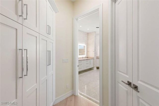 8723 La Palma Ln, Naples, FL 34108 - corridor featuring baseboards and light wood-style floors