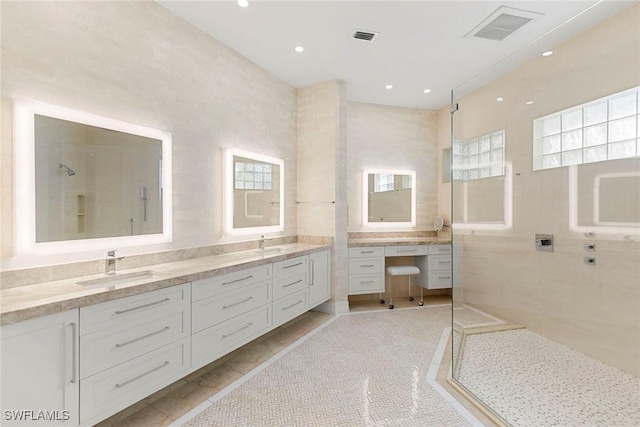 8723 La Palma Ln, Naples, FL 34108 - bathroom featuring double vanity, a walk in shower, recessed lighting, and tile walls