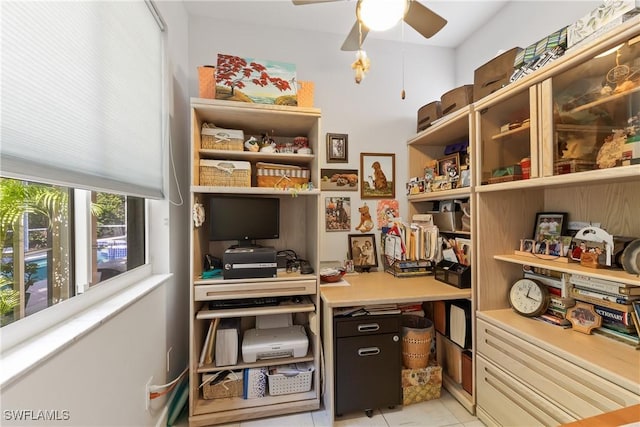 tiled office featuring ceiling fan