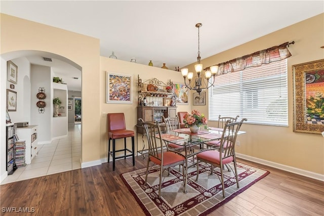 dining room featuring a chandelier and light wood-type flooring