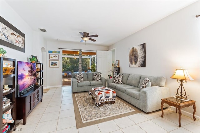 living room with ceiling fan and light tile patterned flooring