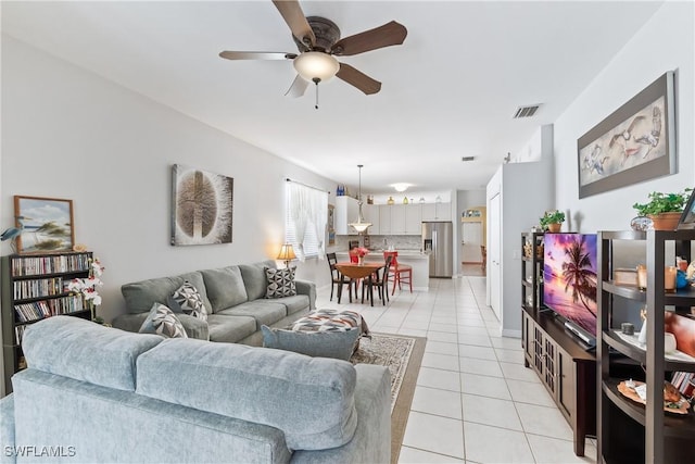 living room featuring ceiling fan and light tile patterned floors