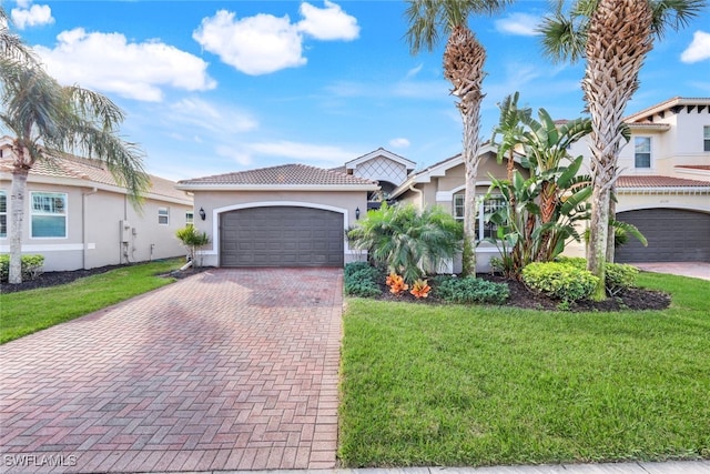 mediterranean / spanish house featuring a front yard and a garage