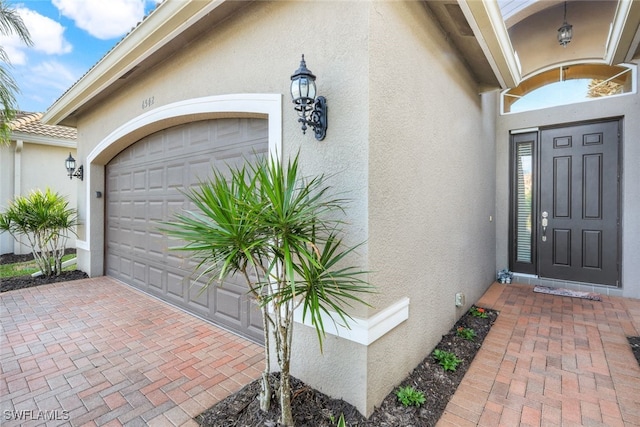 view of exterior entry with a garage