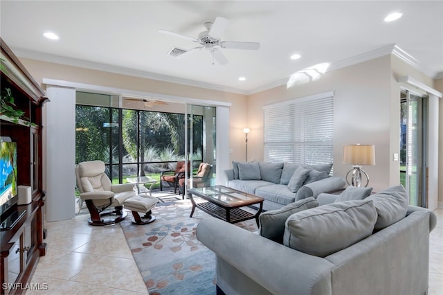 tiled living room with a wealth of natural light, ceiling fan, and ornamental molding