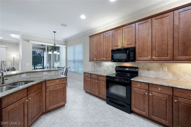 kitchen with light stone countertops, sink, ornamental molding, and black appliances