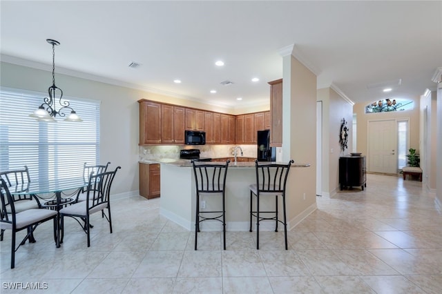 kitchen with an inviting chandelier, black appliances, crown molding, hanging light fixtures, and kitchen peninsula