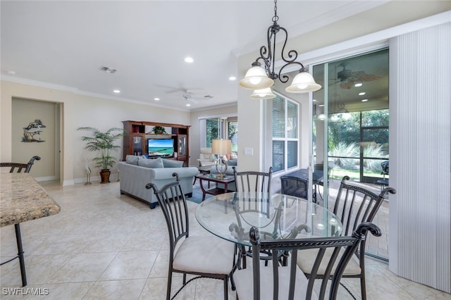 tiled dining room with ceiling fan with notable chandelier and ornamental molding