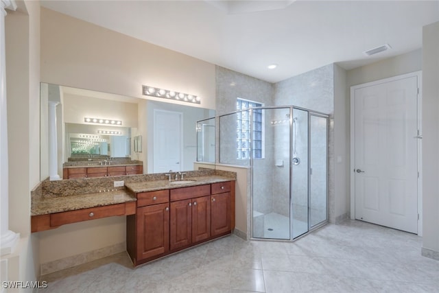 bathroom featuring vanity and an enclosed shower