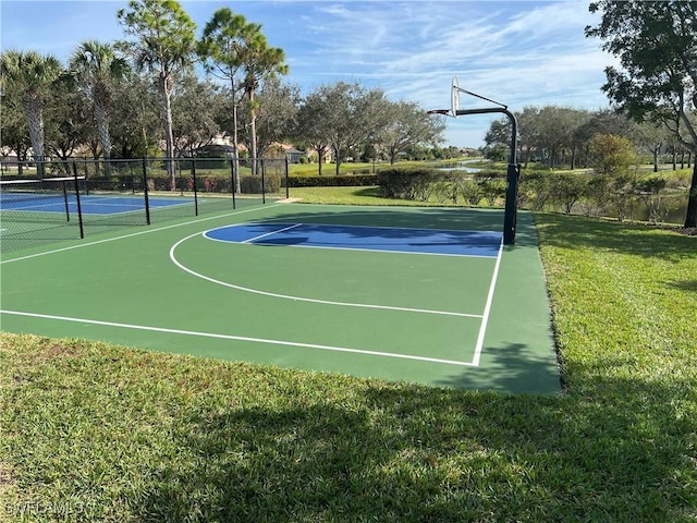 view of sport court with a yard