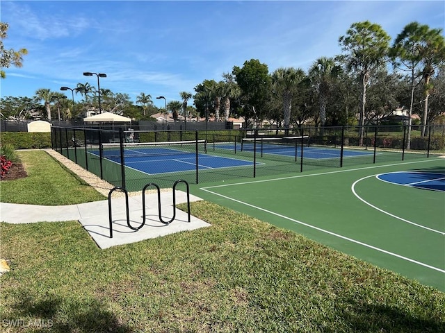 exterior space featuring a lawn and basketball hoop