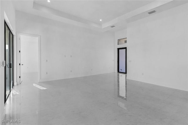 unfurnished room featuring a tray ceiling