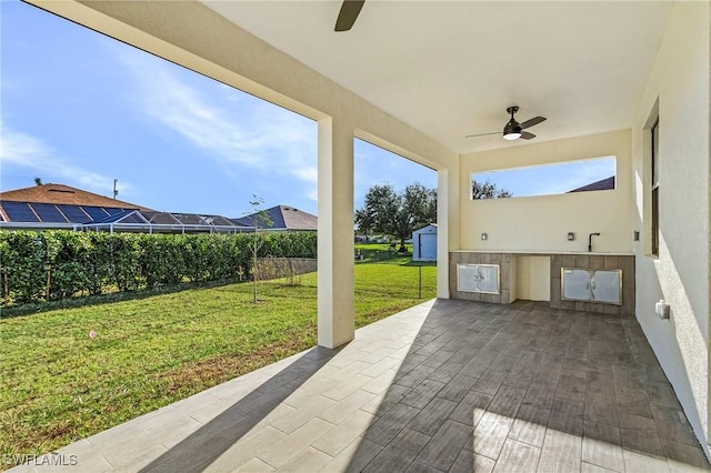 view of patio / terrace with ceiling fan and sink