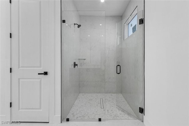 bathroom with a shower with shower door