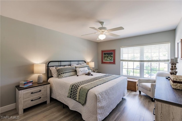 bedroom with ceiling fan and dark wood-type flooring