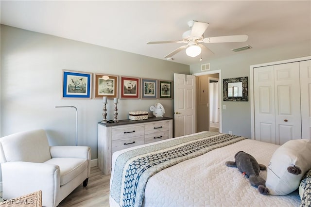 bedroom featuring ceiling fan, a closet, and light hardwood / wood-style flooring