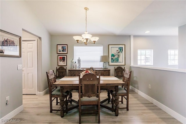 dining room with a chandelier and light hardwood / wood-style flooring