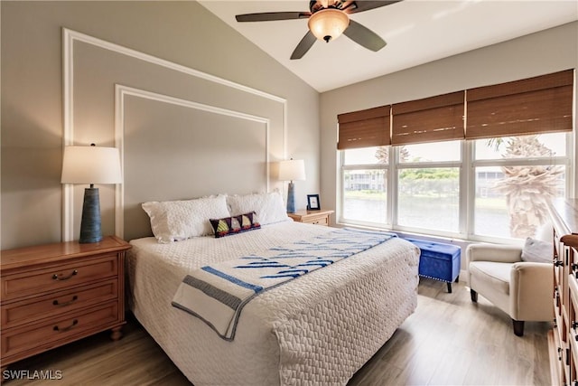 bedroom with hardwood / wood-style flooring, ceiling fan, and lofted ceiling