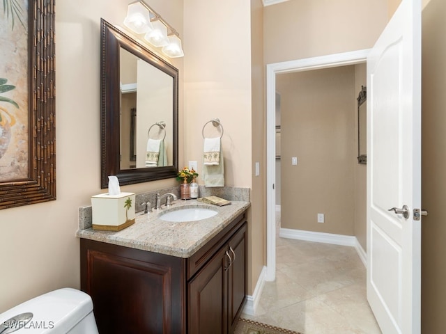 bathroom with tile patterned floors, vanity, and toilet