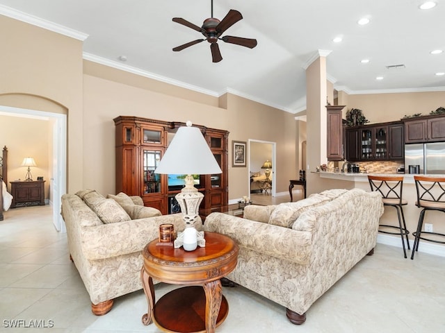 living room featuring ceiling fan, light tile patterned flooring, and crown molding