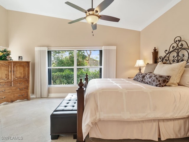 bedroom featuring ceiling fan, ornamental molding, and vaulted ceiling