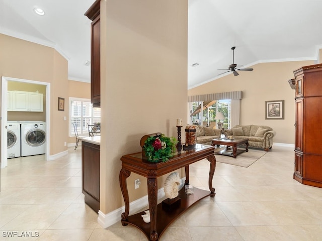 corridor with separate washer and dryer, crown molding, plenty of natural light, and vaulted ceiling