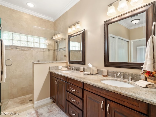 bathroom with vanity, tile patterned floors, a shower with door, and ornamental molding