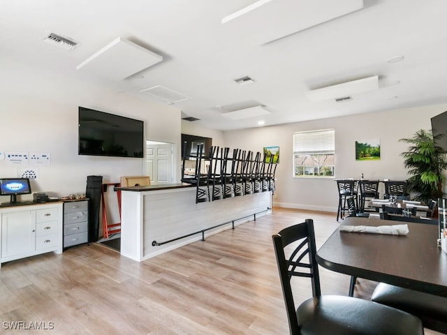 dining space featuring light wood-type flooring