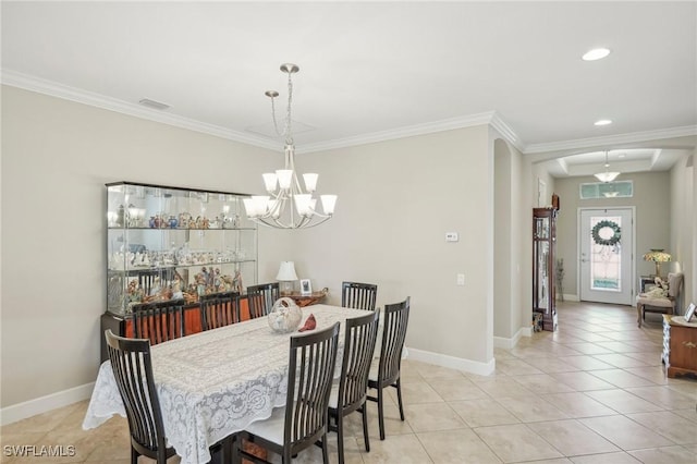 tiled dining space with ornamental molding and a chandelier