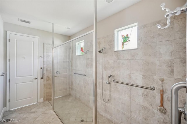 bathroom with tile patterned flooring and an enclosed shower