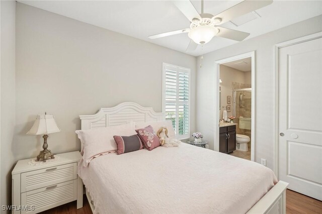 bedroom featuring ensuite bath, ceiling fan, and dark hardwood / wood-style floors