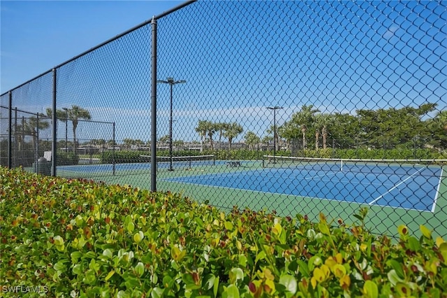 view of tennis court featuring fence