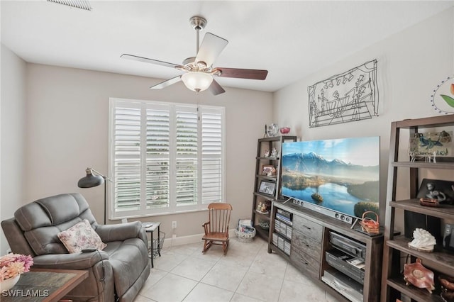 living area with ceiling fan, light tile patterned floors, and a wealth of natural light