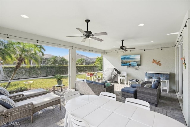 view of patio featuring ceiling fan, area for grilling, and outdoor lounge area