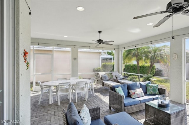 sunroom / solarium featuring ceiling fan