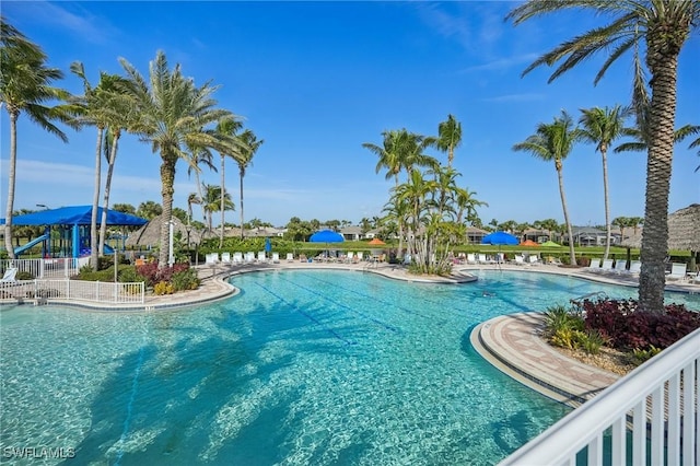 community pool with fence and a patio